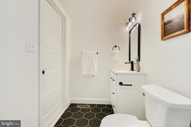 bathroom with tile patterned floors, vanity, and toilet