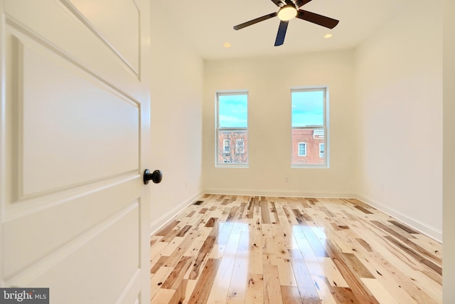 empty room featuring hardwood / wood-style flooring and ceiling fan