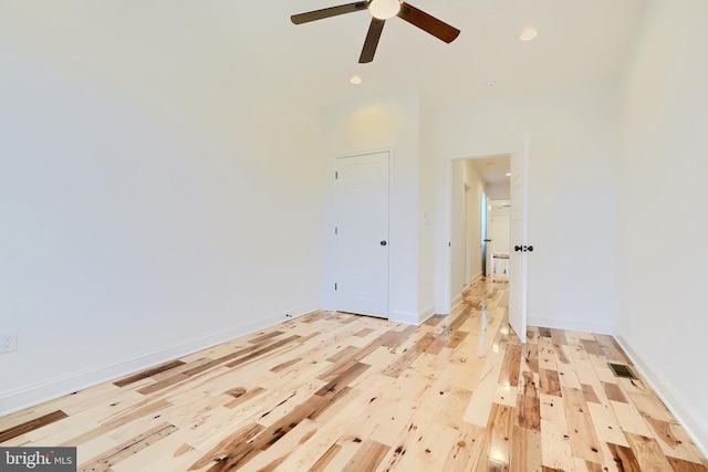 unfurnished room with light wood-type flooring and ceiling fan