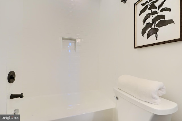 bathroom featuring washtub / shower combination and toilet