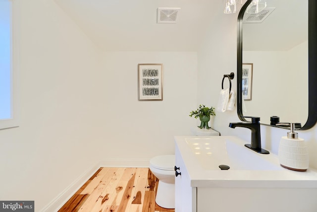 bathroom featuring hardwood / wood-style floors, vanity, and toilet