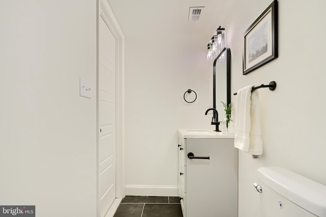 bathroom featuring toilet, vanity, and tile patterned floors