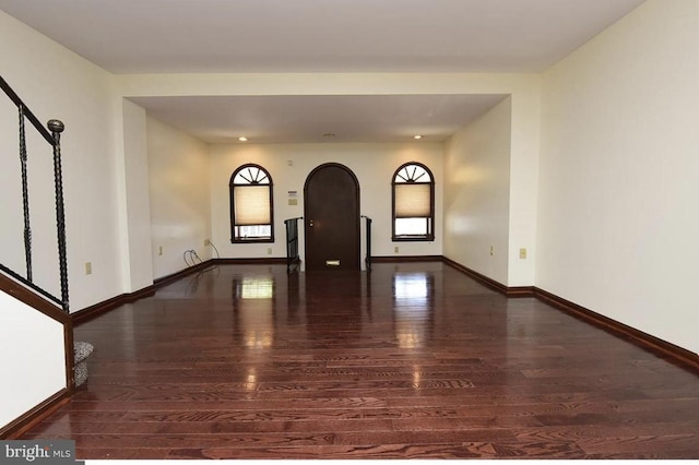 spare room with dark wood-type flooring