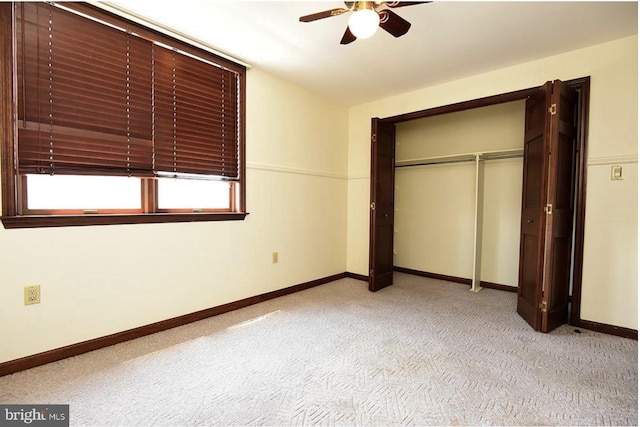 unfurnished bedroom with light carpet, a closet, and ceiling fan