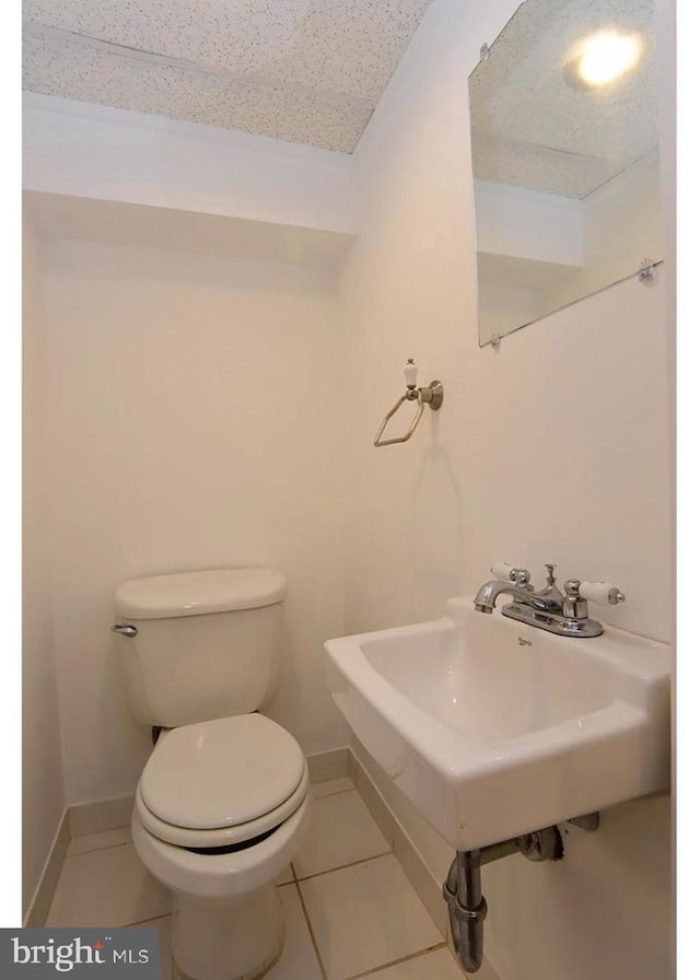 bathroom with tile patterned floors, sink, and toilet