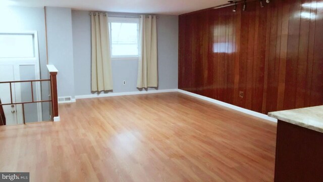 1221 W Jefferson St, Philadelphia, PA 19122 - spare room featuring light wood-style flooring, wooden walls, and baseboards