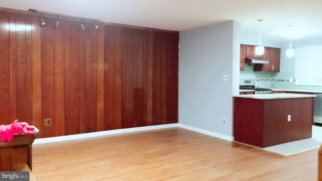 1221 W Jefferson St, Philadelphia, PA 19122 - kitchen featuring range, under cabinet range hood, light wood finished floors, light countertops, and dishwasher