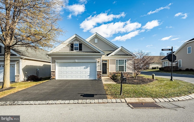 view of front of home with a garage and a front lawn