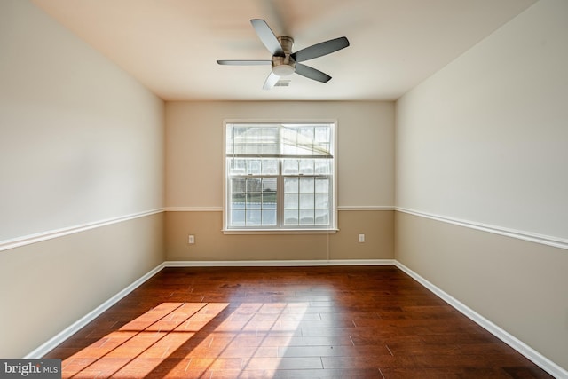 unfurnished room featuring dark wood-type flooring and ceiling fan