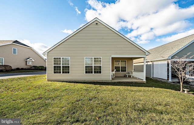 back of house with a yard and a patio area