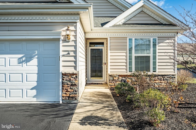 view of exterior entry featuring a garage