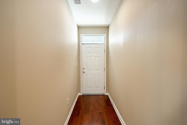 hallway with dark hardwood / wood-style flooring