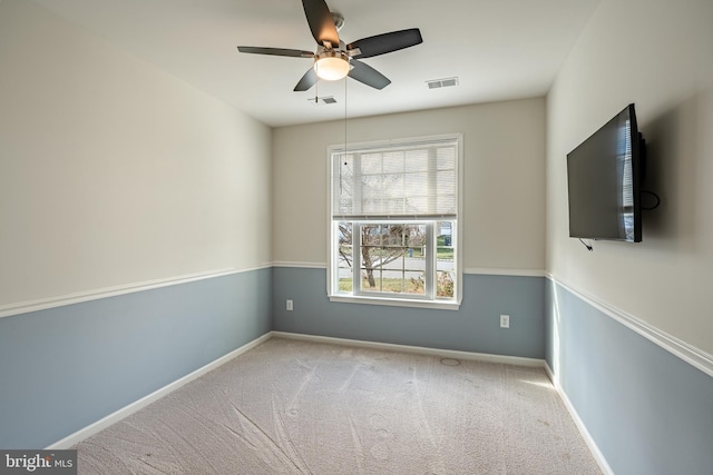 carpeted empty room featuring ceiling fan