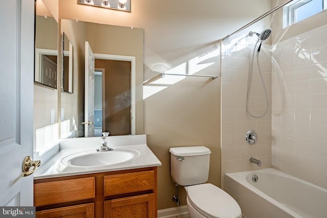 full bathroom with tiled shower / bath combo, vanity, and toilet