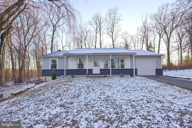 ranch-style house with a porch and a garage