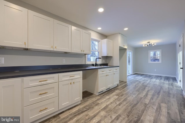 kitchen featuring sink, white cabinets, and light hardwood / wood-style floors