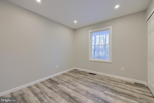 unfurnished room with light wood-type flooring