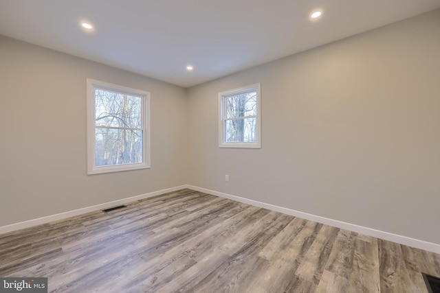 unfurnished room with light wood-type flooring