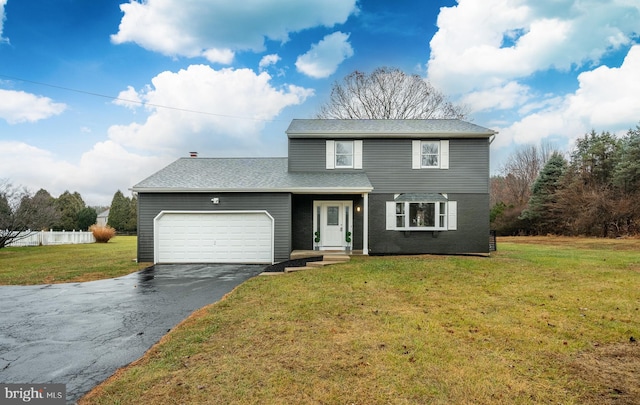 front of property featuring a front yard and a garage