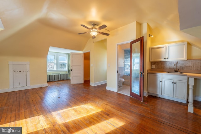 bonus room with lofted ceiling, sink, light wood-type flooring, radiator, and ceiling fan