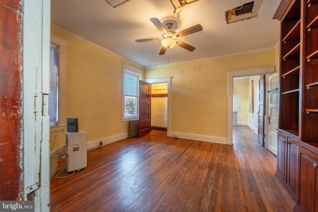 empty room with ornamental molding, dark hardwood / wood-style floors, and ceiling fan