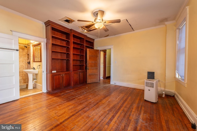 unfurnished bedroom with ornamental molding, dark hardwood / wood-style floors, and connected bathroom