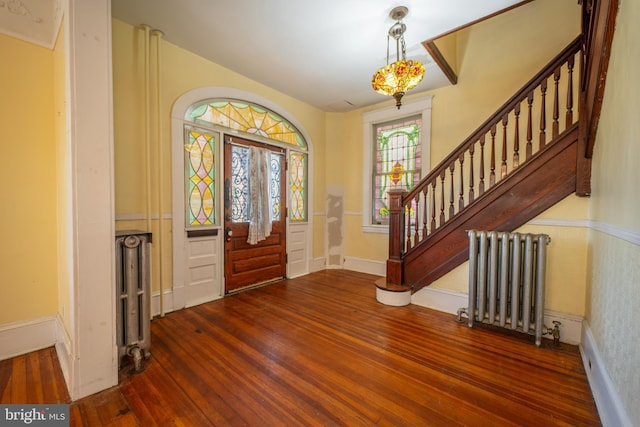 foyer with wood-type flooring and radiator