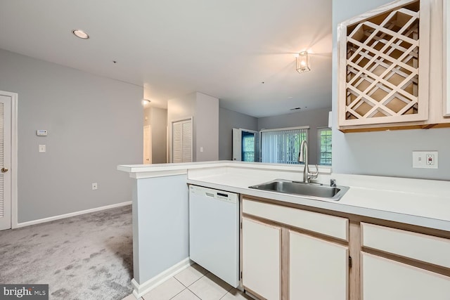 kitchen with white cabinetry, sink, kitchen peninsula, white dishwasher, and light carpet