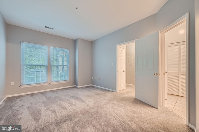 unfurnished bedroom with light colored carpet