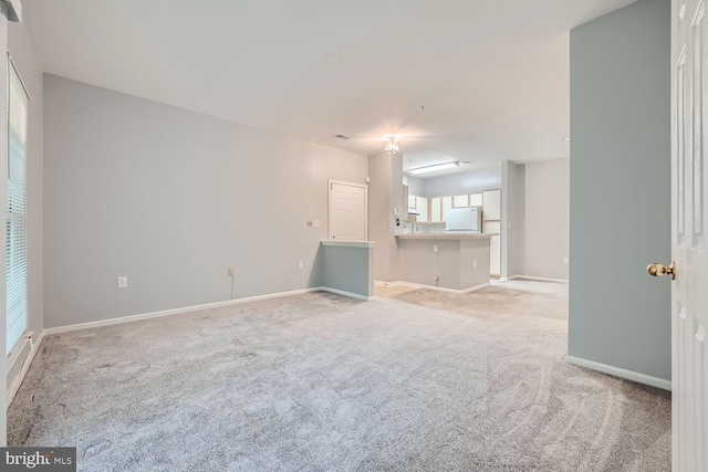 unfurnished living room featuring light colored carpet