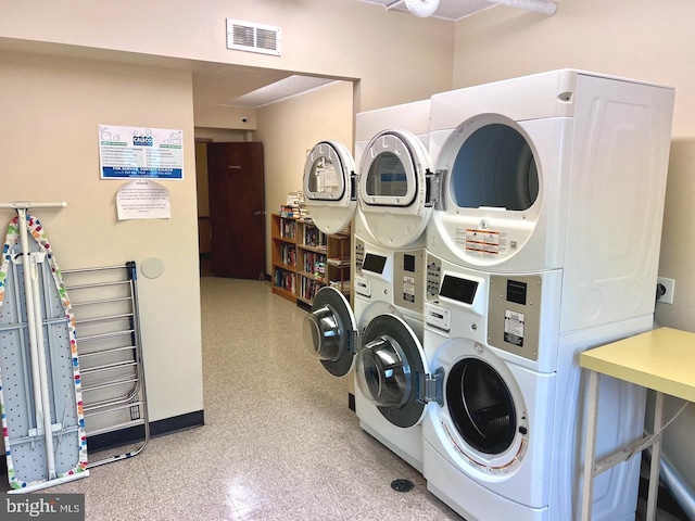 clothes washing area with stacked washer / drying machine