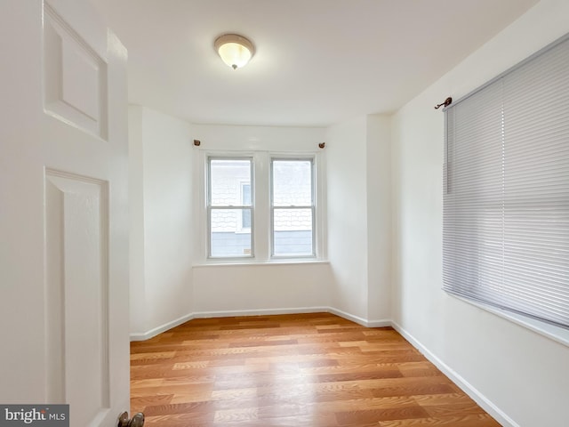 unfurnished room with light hardwood / wood-style floors