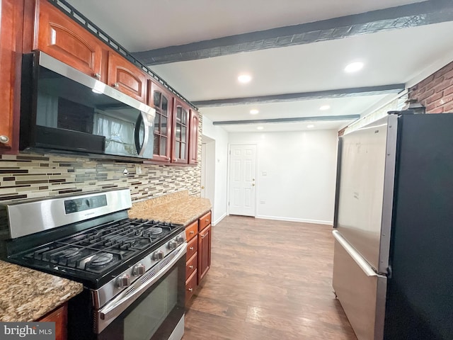 kitchen with backsplash, light stone counters, stainless steel appliances, beam ceiling, and wood-type flooring