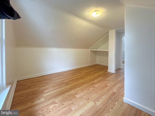 bonus room featuring light hardwood / wood-style flooring and lofted ceiling