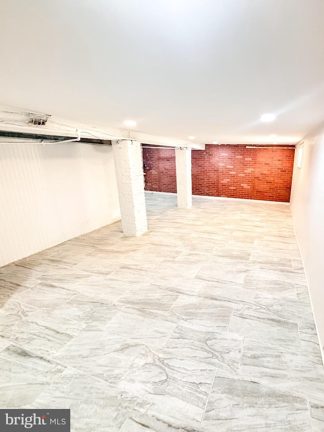 basement with brick wall