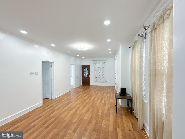 hallway featuring light hardwood / wood-style flooring and ornamental molding