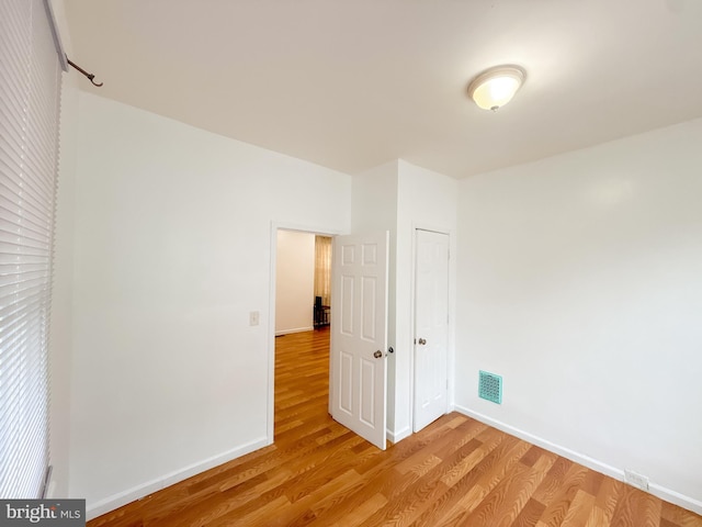 unfurnished room with light hardwood / wood-style floors