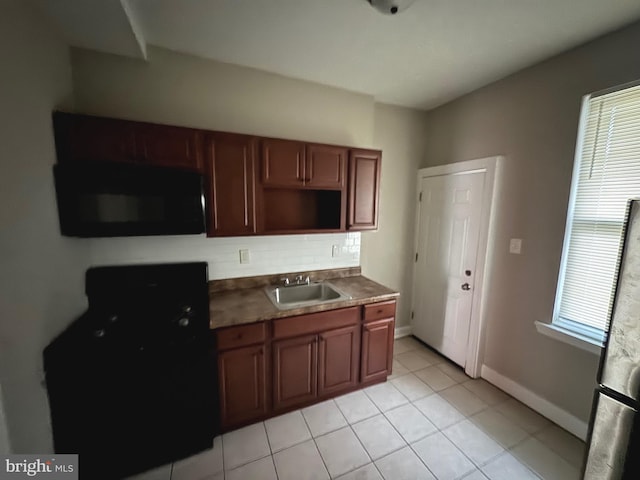 kitchen featuring sink and light tile patterned floors