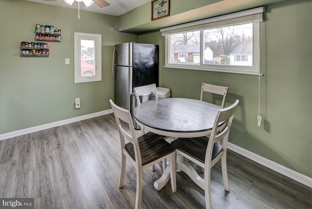 dining space with ceiling fan and light hardwood / wood-style floors