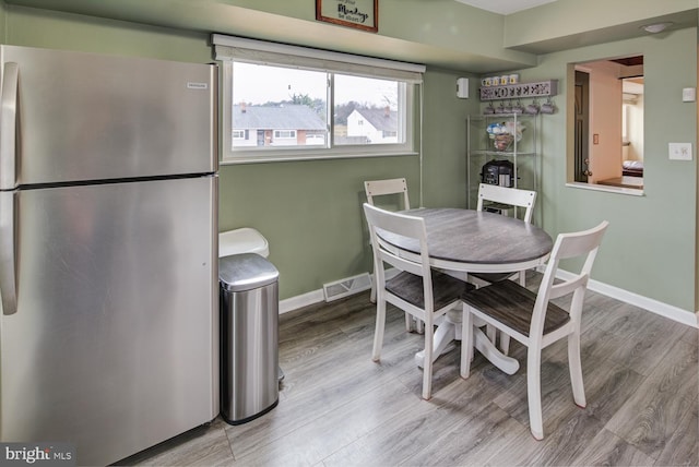 dining room with light hardwood / wood-style flooring