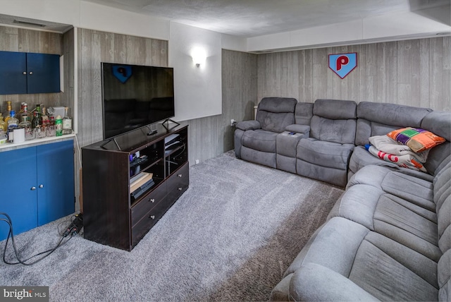 carpeted living room with wooden walls