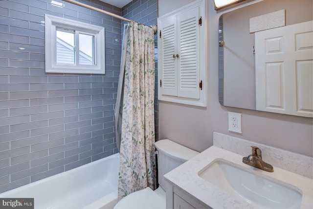 full bathroom with vanity, shower / bath combo, and toilet