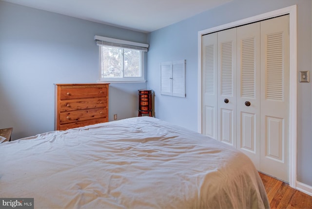 bedroom with a closet and light hardwood / wood-style flooring