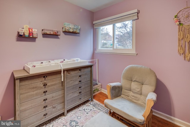 sitting room with hardwood / wood-style flooring