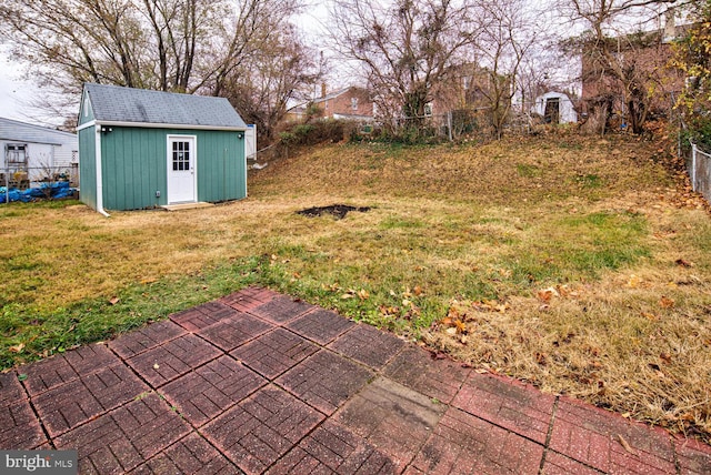 view of yard featuring a storage unit and a patio area