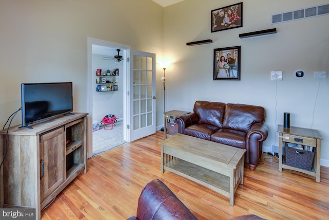 living room featuring ceiling fan and light hardwood / wood-style flooring