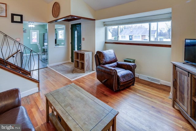 living room featuring light wood-type flooring and ceiling fan