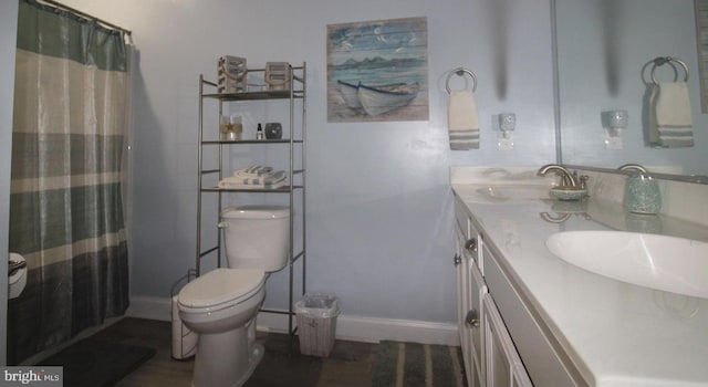 bathroom with vanity, toilet, and a shower with shower curtain