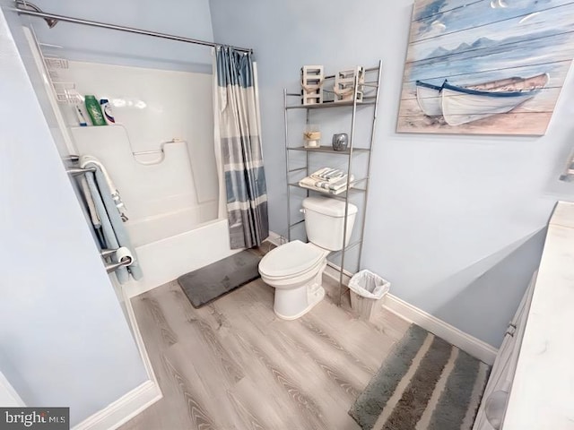 bathroom with shower / bathtub combination with curtain, wood-type flooring, and toilet