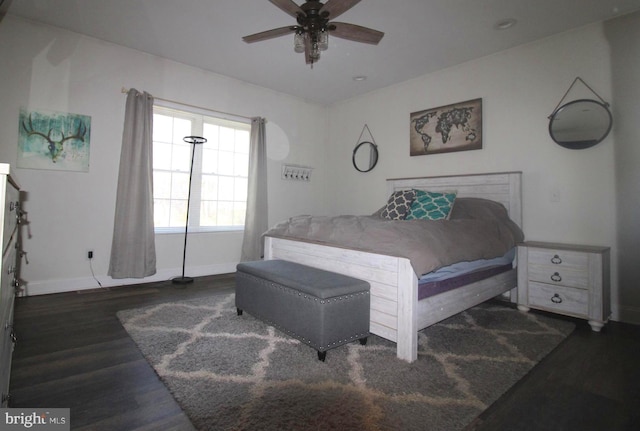 bedroom with dark hardwood / wood-style flooring and ceiling fan